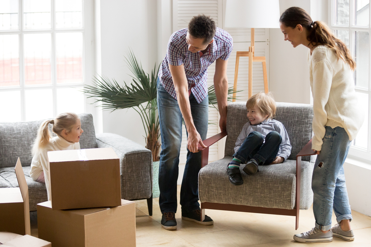 little boy sitting on chair moving into apartment