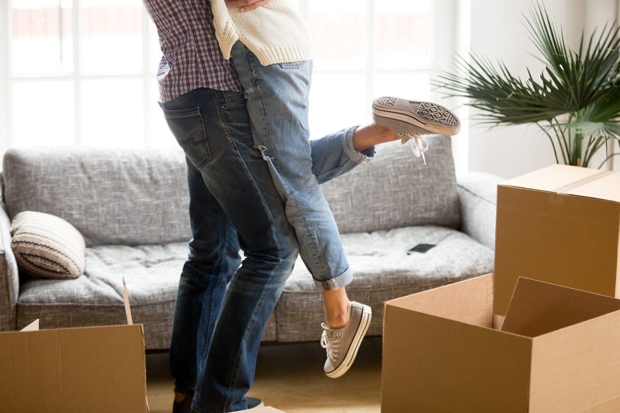 man hugging and lifting woman off ground